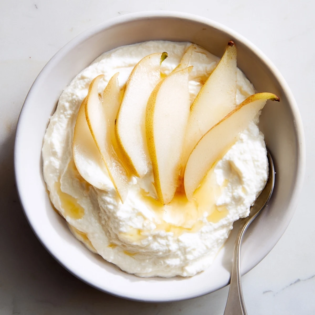 Light and airy sweet ricotta served elegantly with sliced apples and pears.