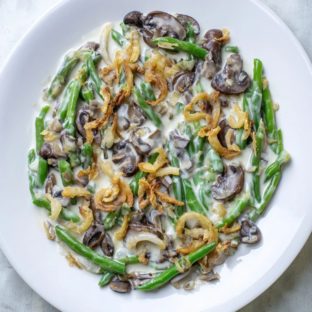 Imagine creamy old-school green bean casserole, a comforting, savory holiday family side with golden onions.