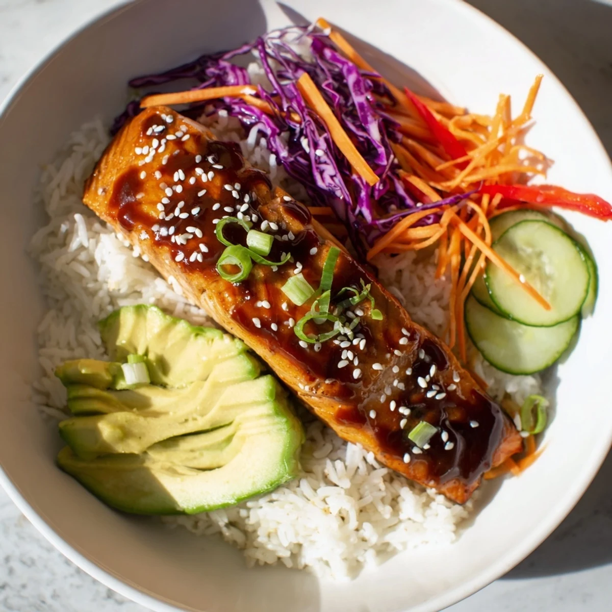 Sweet chili salmon rice bowl with vibrant colors and glistening glaze, ready to eat.