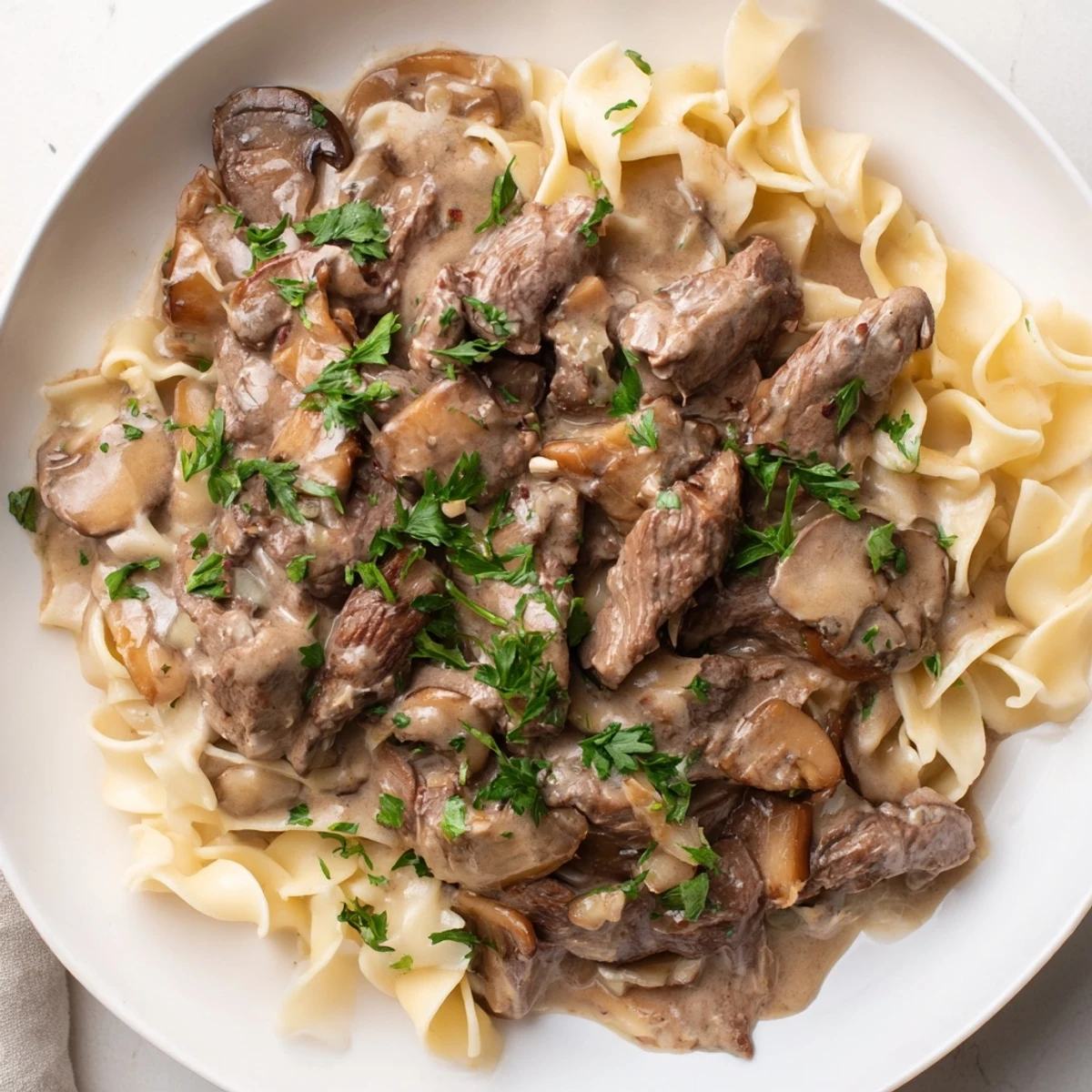 Creamy Mushroom Beef Stroganoff with noodles, a hearty savory dish with rich, creamy sauce and tender beef.