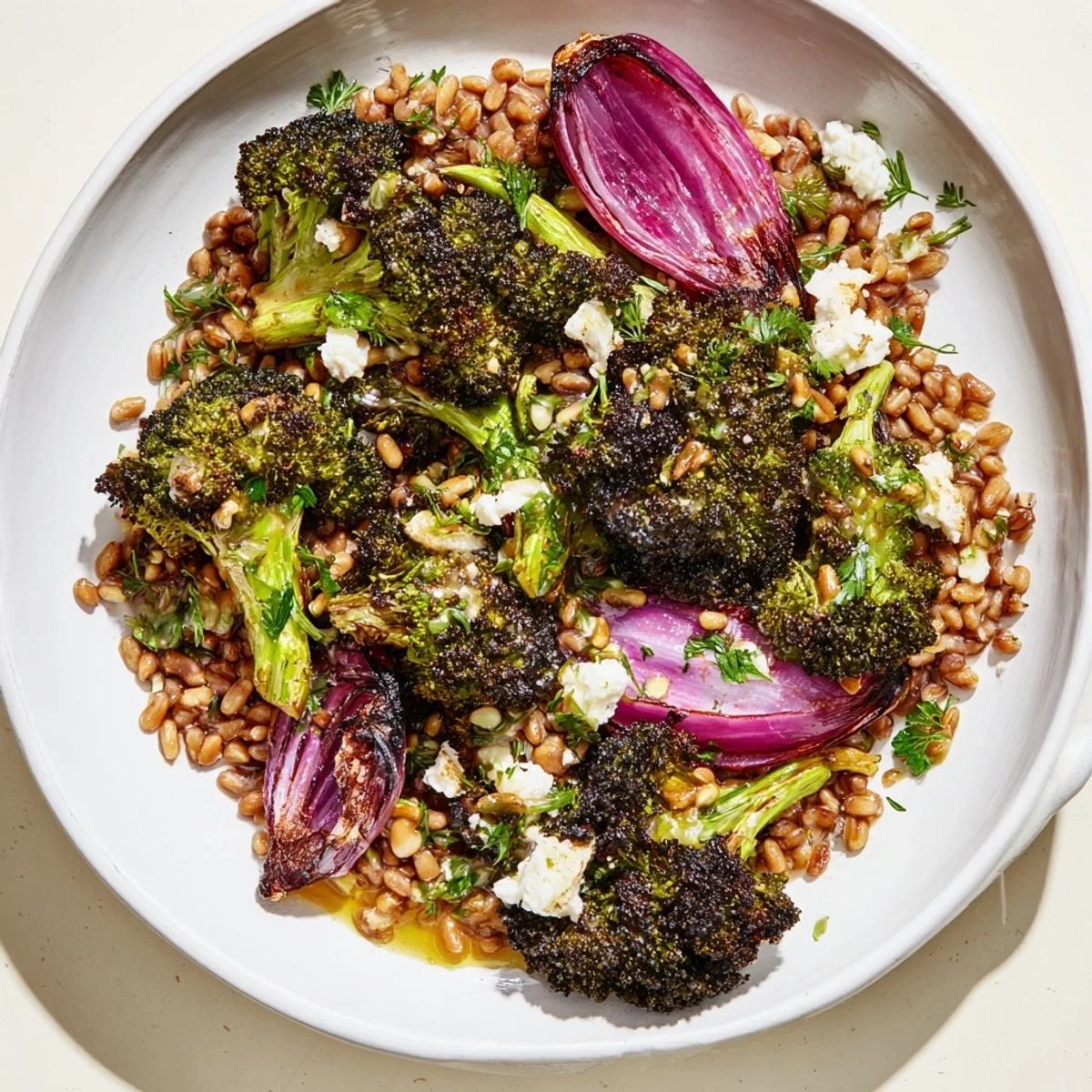Golden roasted broccoli with garlic-lemon dressing served over a bed of farro, a delicious meal.