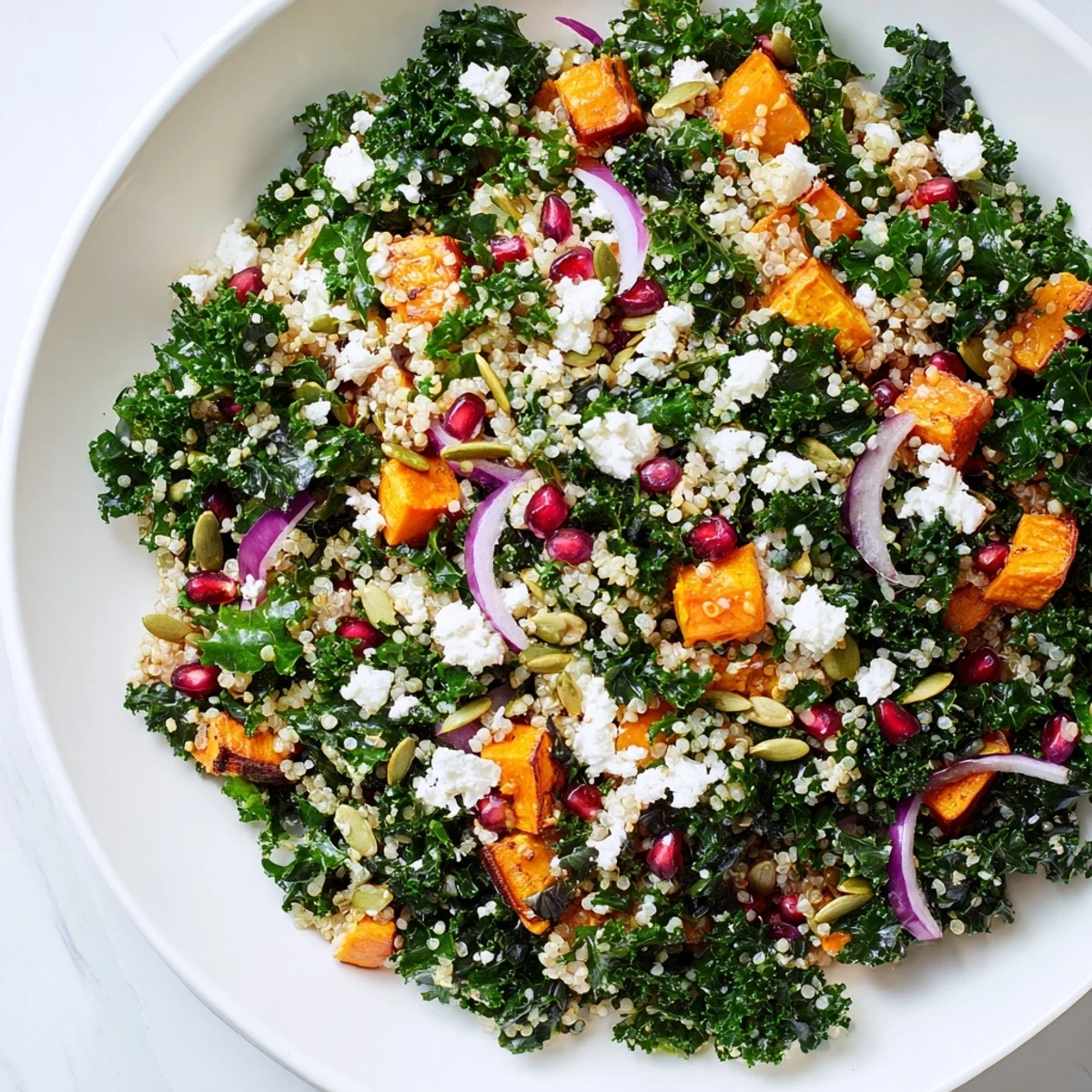 Vibrant Kale & Quinoa Salad with roasted sweet potato, ready to eat, served with zesty lemon dressing.