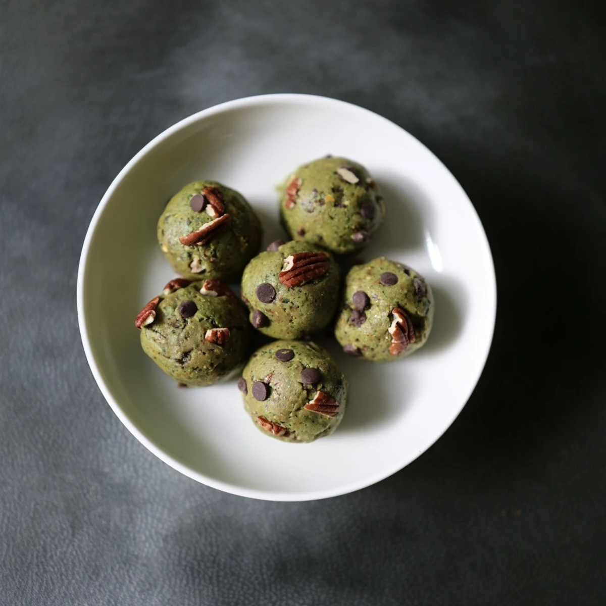 Vibrant image of Matcha Gingerbread Cookie Dough Protein Bites, textured and spiced, ready to chill and enjoy.