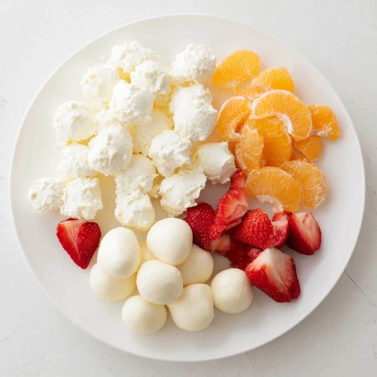 A visually stunning Cloud & Rainbow Grazing Board, perfect for a kids' party, filled with colorful ingredients.