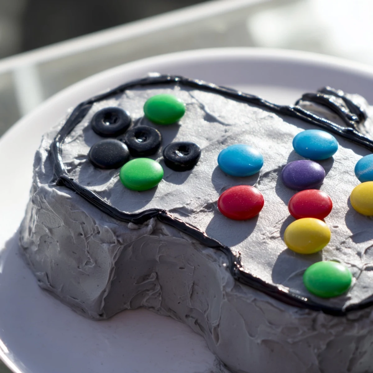Vibrant Pixel Perfect Video Game Controller Board cake with colorful frosted buttons ready to enjoy.