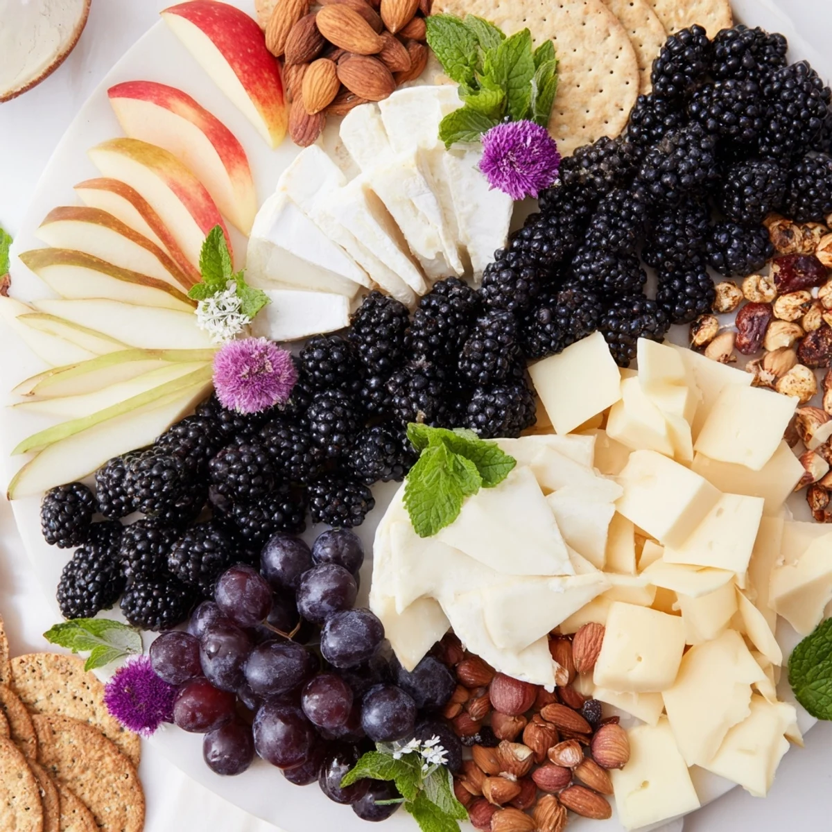 Visually, the Yin-Yang appetizer board showcases a blackberry-divided platter with contrasting fruit, cheeses, and crackers.