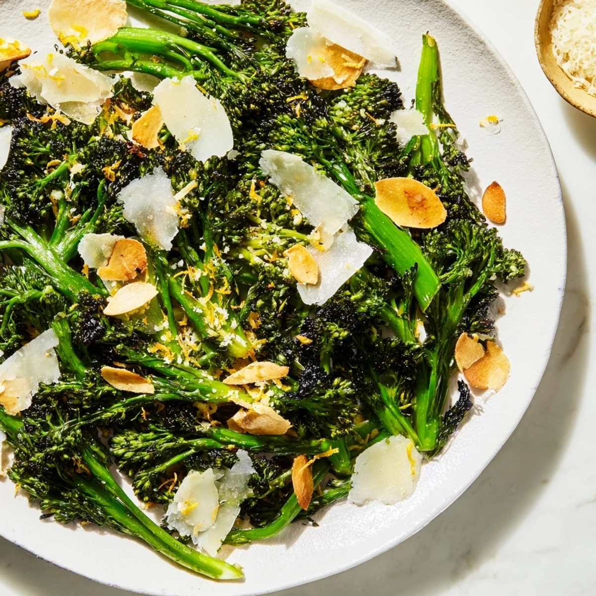 Air-fried Charred Broccolini Salad with crispy garlic and shaved Parmesan, a delicious vegetarian dish.
