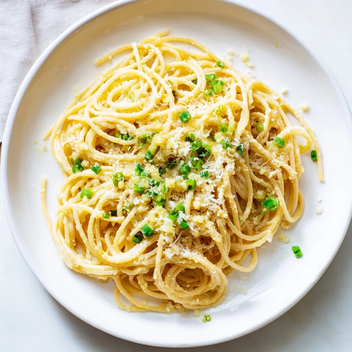 Creamy, umami-rich miso butter pasta, featuring perfectly twirled spaghetti and fresh chives.