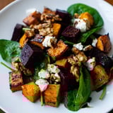 Freshly tossed roasted beet and butternut salad, drizzled with balsamic vinaigrette, ready to serve.