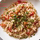Bright red diced tomatoes and fluffy rice star in this comforting Tomato-Rice Skillet Dinner.