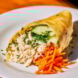 Crispy pan-fried Garlicky Pulled Chicken Wraps, vibrant with fresh vegetables and seasoned garlic butter.