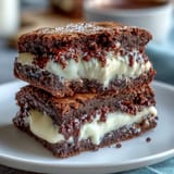 Decadent cream cheese stuffed brownie cookies with gooey chocolate centers and a soft, chewy texture.