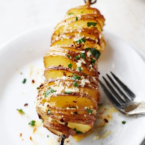 Crispy Air-Fryer Tornado Potatoes skewers topped with Parmesan and fresh parsley.  