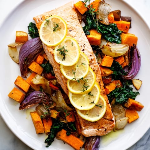 Flaky, roasted Sheet-Pan Salmon with vibrant root veggies and wilted greens, a complete dinner.