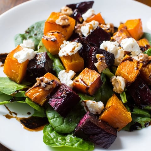 Vibrant roasted beet, butternut squash & spinach salad topped with creamy goat cheese and walnuts.