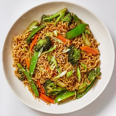 Steaming hot Ramen Noodle Stir-Fry Remix with colorful vegetables and a glistening savory sauce.