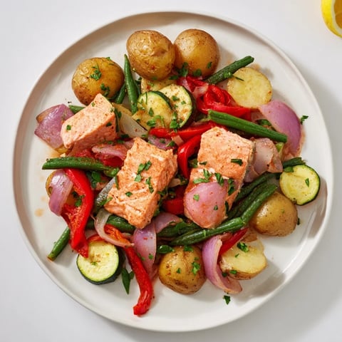 Golden, flaky salmon and potato skillet with vibrant vegetables, perfectly cooked for dinner.