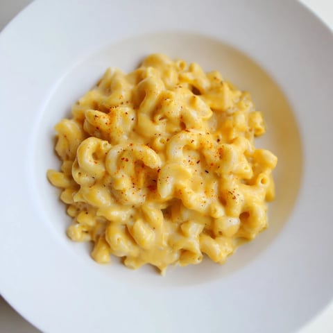 A close-up of creamy one-pot butternut squash mac & cheese, garnished beautifully before serving.