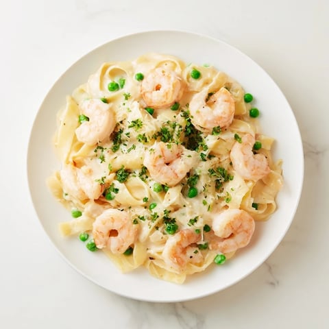 Steaming Instant Pot Shrimp Alfredo Pasta, finished with fresh parsley and ready to serve.