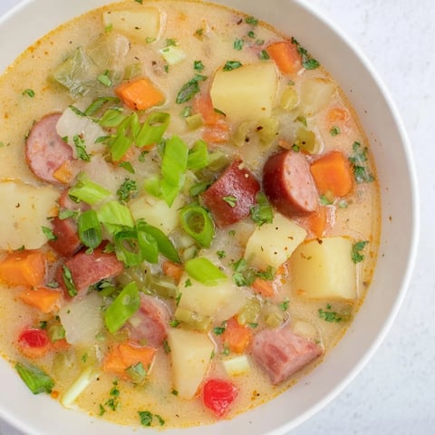 Creamy Slow Cooker Cajun Potato Soup with vibrant vegetables, ready for a cozy weeknight.