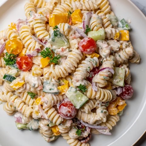 Festive Greek Yogurt Million Dollar Christmas Pasta Salad with diced cheese and vibrant vegetables.