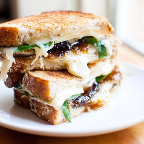 Crispy golden Fig, Brie & Arugula Grilled Cheese with melted Brie and fresh arugula.