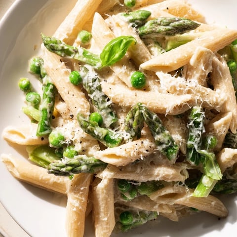 Steamy, fork-tender penne in a creamy garlic-Parmesan sauce, loaded with bright asparagus, peas, and green beans.