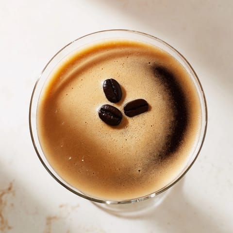 Making an Espresso Martini: shaking vigorously to chill the vodka, liqueur, and espresso.