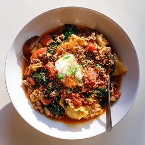 Bowl of hearty Lasagne Soup with Kimchi Crunch, perfect for cozy nights.  