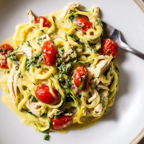 Delicious low-carb One-Pot Zucchini Noodle Alfredo featuring tender shredded chicken.  