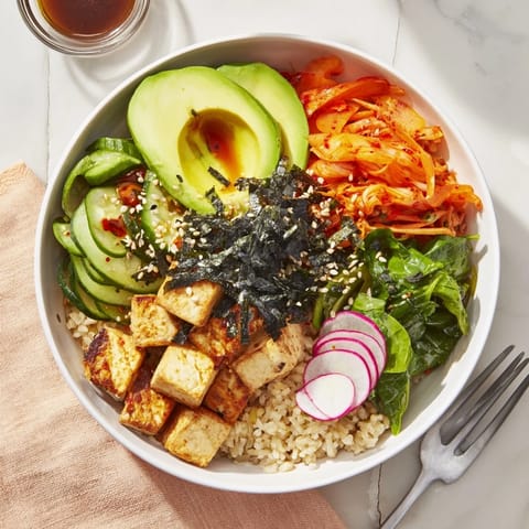Vibrant Fermented Vegetable Bowl showcasing hearty grains, kimchi, and creamy avocado slices.  