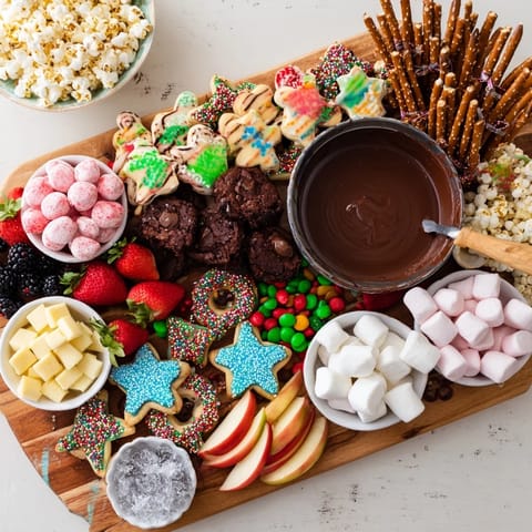 Delightful dessert board with assorted goodies, perfect for festive gatherings or game nights.  