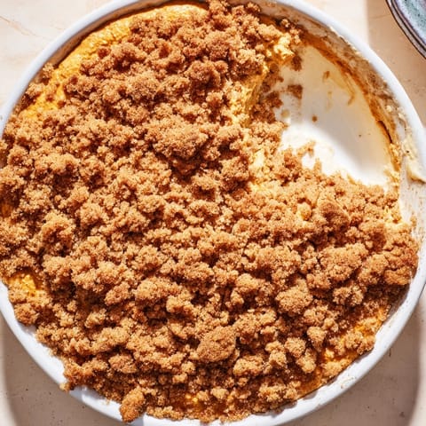 A close-up shot of the bubbly pumpkin crisp, showcasing the buttery crumble topping texture.