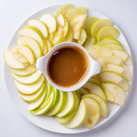 A close-up of the bright, colorful Apple Slices with Caramel Dip ready for sharing.
