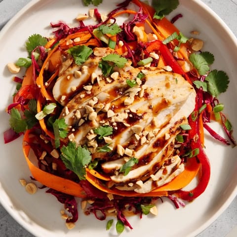 Imagine a close-up: vibrant carrot ribbons with juicy chicken in this delicious slaw recipe.