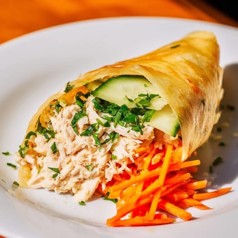 Crispy pan-fried Garlicky Pulled Chicken Wraps, vibrant with fresh vegetables and seasoned garlic butter.