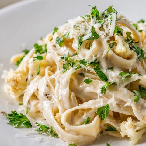 Golden roasted cauliflower florets and garlic blend into a creamy vegetarian Alfredo sauce for pasta.  