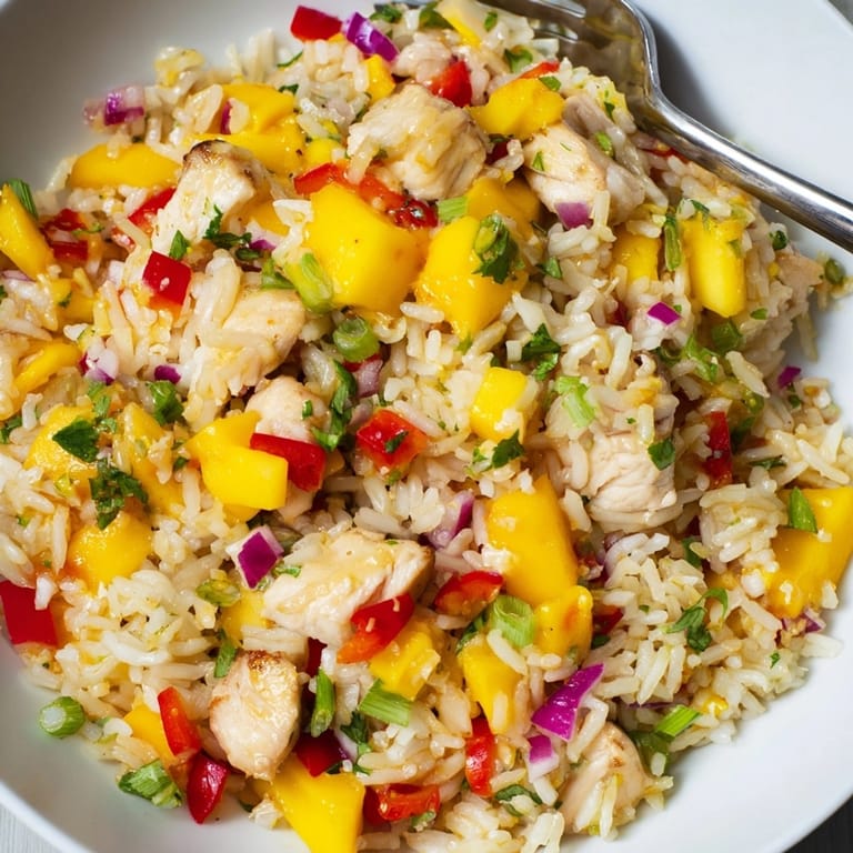 Bowl of brightly colored Mango Cilantro Chicken Rice: a delicious, gluten-free family meal.