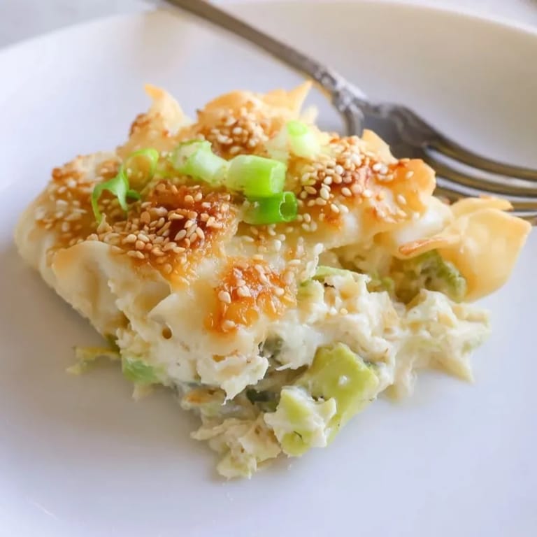 Creamy Avocado Crab Rangoon Bake with flaky wonton topping, perfect appetizer or easy dinner.