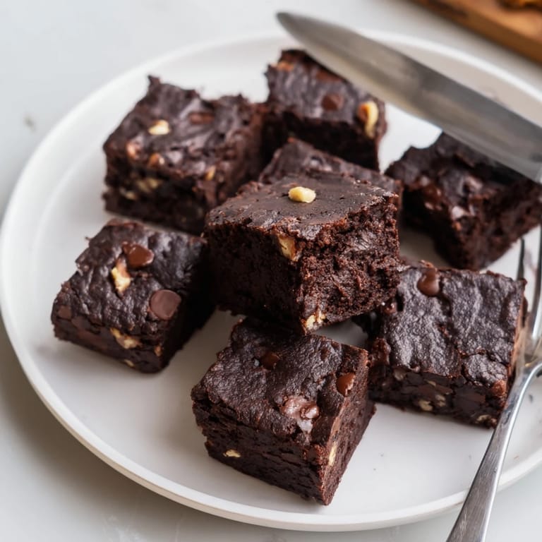 Deliciously fudgy Zero-Waste Brownies topped with nuts, perfect for dessert lovers.  