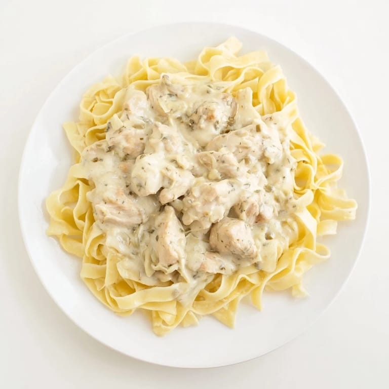 Golden chicken breasts bathed in a rich Alfredo sauce, a taste of this homemade Creamy Chicken Alfredo.