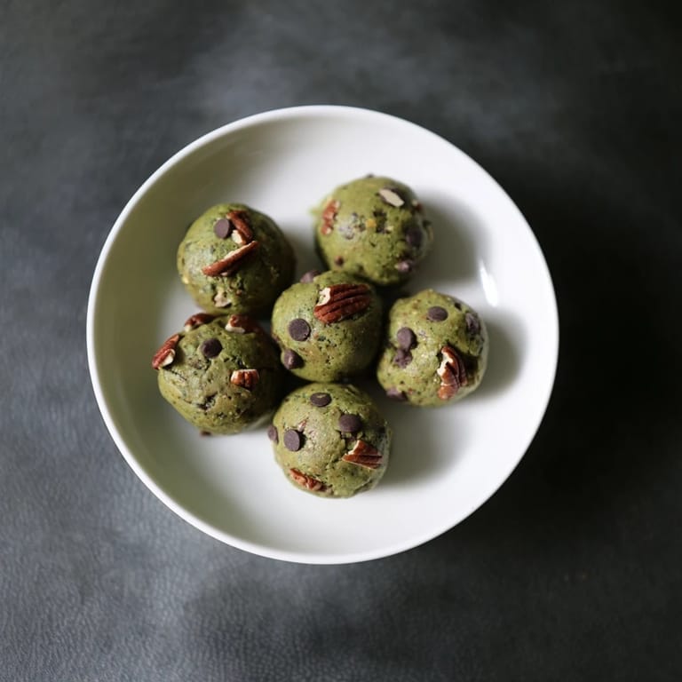 Vibrant image of Matcha Gingerbread Cookie Dough Protein Bites, textured and spiced, ready to chill and enjoy.