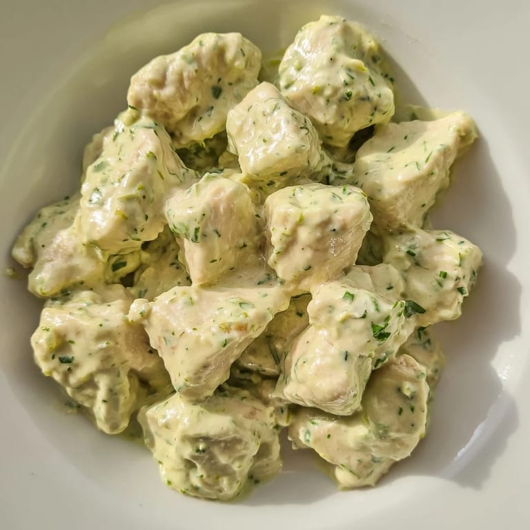 Cool, creamy Green Goddess Chicken Salad with baked chicken breast, fresh herbs, and cherry tomatoes served over mixed salad greens.
