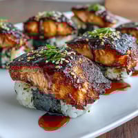Grilled salmon onigiri with crispy rice exterior and savory salmon filling.  